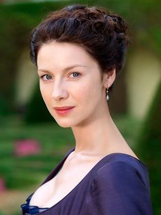 a woman in a blue dress posing for a photo