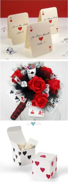 some cards and flowers are sitting on a table with red roses in the middle, and two