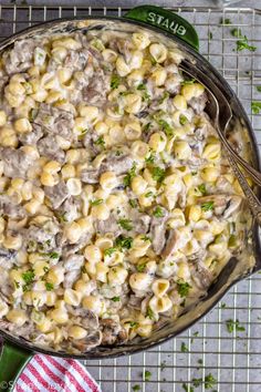 a skillet filled with macaroni and cheese on top of a cooling rack