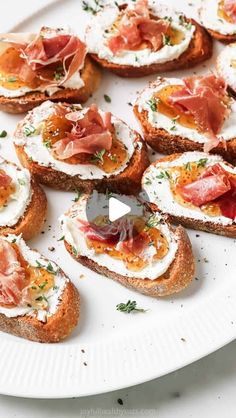 a white plate topped with toasted bread covered in toppings