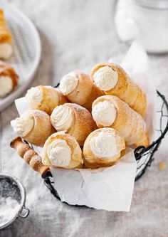 a basket filled with pastries sitting on top of a table