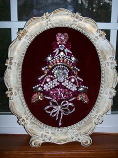 a christmas tree made out of jewels in a frame