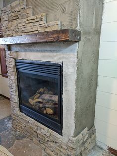 a fire place in the middle of a room under construction