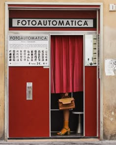 an open red door with the words fotoautomatica written on it