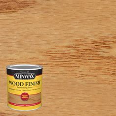 a can of wood finish sitting on top of a wooden table