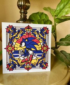 a card with an image of sonic the hedgehog on it next to a potted plant