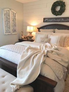 a bed with white sheets and pillows in a bedroom