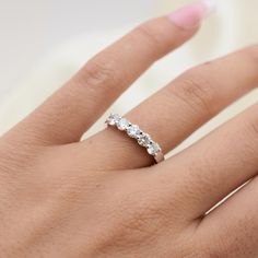 a woman's hand with a diamond ring on it