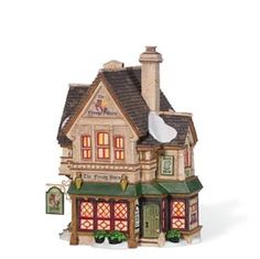 a small toy house with lights on the front and side windows, sitting in front of a white background