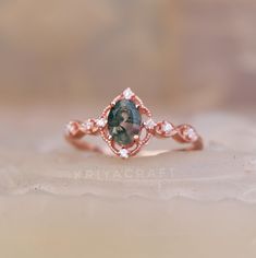 a close up view of a ring with an oval shaped blue stone in the center