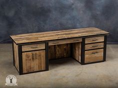 a desk made out of wood with two drawers on the top and one drawer open