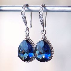 Sapphire Blue Jeweled Teardrop Earrings in Silver Cheap Blue Teardrop Earrings For Gift, Affordable Blue Hypoallergenic Teardrop Earrings, Cheap Blue Crystal Earrings For Party, Luxury Sapphire Teardrop Jewelry, Cheap Blue Earrings For Gift, Cheap Blue Crystal Earrings, Luxury Sapphire Teardrop Earrings, Sapphire Earring, Crystal Teardrop Earrings