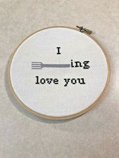 a cross stitch pattern with the words i love you and an image of a fork