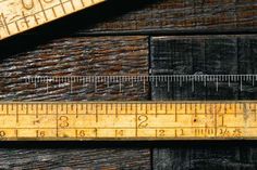 a wooden table topped with a ruler and a pair of scissors