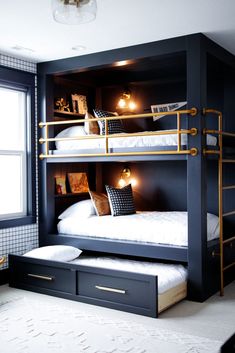 a bunk bed with two sets of drawers underneath it and lights on the top shelf