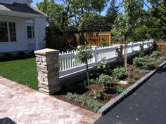 a white picket fence in front of a house