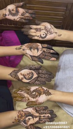 several hands with henna designs on them