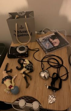 a wooden table topped with assorted items and a bag on top of the table