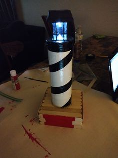 a lighthouse made out of books sitting on top of a table