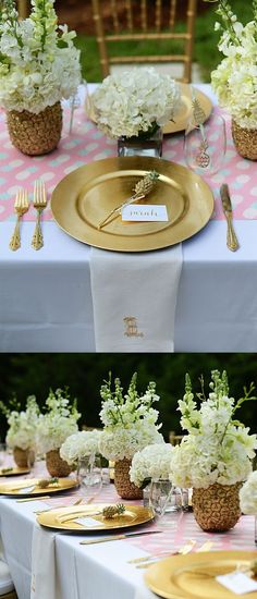 the table is set with white flowers and gold plates