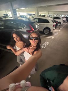 two women taking a selfie in a parking garage