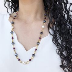 This beautiful necklace is perfect for those looking for an elegant and refined jewel. Handcrafted from high-quality gold-filled steel, it features an array of luminous and lustrous black Bohemian crystals, which catch the light enchantingly. The freshwater pearls, round and smooth, alternate with crystals, giving the necklace an even more precious and sophisticated appearance. The choice of purple semiprecious stones gives a touch of color to the necklace, creating a beautiful chromatic effect. The necklace is a perfect length for everyday wear or for a special occasion, and is lightweight and comfortable to wear. The elegant and luxurious design pairs perfectly with any type of clothing, from a simple t-shirt to the most elegant evening dress. This necklace with Bohemian crystals, freshw Elegant Long Pearl Necklace With Natural Stones, Elegant Long Necklace With Round Natural Stones, Elegant Black Long Necklace For Gift, Elegant Gold Long Necklace With Natural Stones, Elegant Long Gold Necklace With Natural Stones, Elegant Long Necklace With Natural Stones For Gift, Elegant Long Necklace With Natural Stones, Elegant Long Necklace For Jewelry Making With Gemstone Beads, Elegant Long Necklace With Gemstone Beads For Jewelry Making