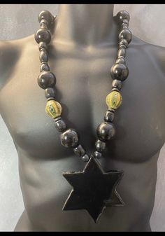 Seven miles of black star liner! Marcus Garvey organise and centralise! This handmade necklace is made entirely of wood, handcut to perfection. Hangs on a variety of handpainted wooden beads  Necklace 36 inches long and pendant 3/and half inches wide Star Liner, Marcus Garvey, Wooden Bead Necklaces, Black Star, Beads Necklace, Handmade Necklace, Star Necklace, Unique Necklaces, Punk Fashion