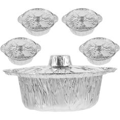 four pieces of aluminum foil with the lid open and five silver dishes in front of it