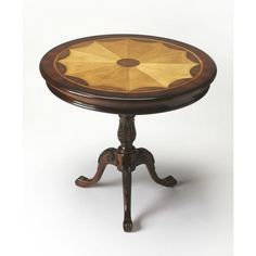 an antique wooden table with umbrella design on it's top and legs, against a white background