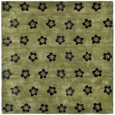 a green rug with black flowers on it