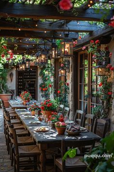 an outdoor dining area with flowers and potted plants