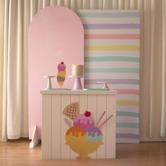 an ice cream shop with pink walls and white curtains