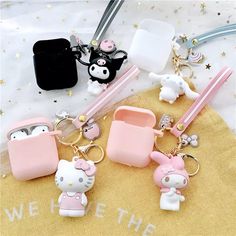 hello kitty keychains are sitting on a table with other items in the background