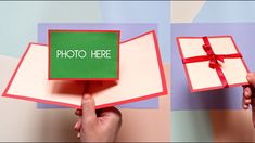 someone holding up a card with the word photo here on it and a red ribbon