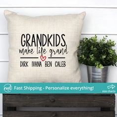 a pillow sitting on top of a wooden crate next to a potted plant