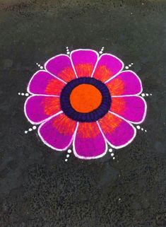 a colorful flower is drawn on the ground