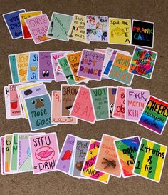 many different cards are laid out on the floor to be used as an art project