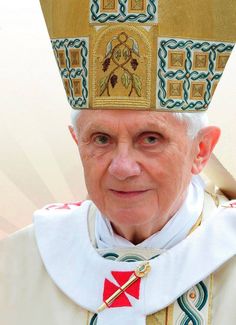 an older man wearing a priest's hat and cross on his head with gold trim