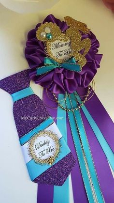 a purple and blue tie with a name tag on it next to a brooch