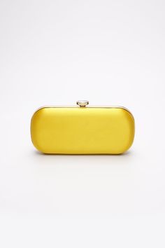 The Limoncello Yellow Bella Clutch is a bold yellow bridal handbag, crafted with duchess satin by Italian artisans featuring a lively pop of color. Planning a maximalist wedding day or looking to make a powerful statement at your next gala? Inspired by Italy’s Amalfi Coast, a coastline featuring terraced vineyards and cliffside lemon groves, this luxury handbag will make a statement on your wedding day, at a red-carpet affair, or on a tropical destination trip. First seen on celebrity stylist Mi Yellow Clutch Bag, Maximalist Wedding, Bridal Handbag, Cc Jewelry, Yellow Bags, Red Carpet Affair, Italian Handbags, Yellow Clutch, Yellow Purse