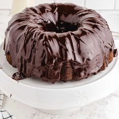 a chocolate bundt cake sitting on top of a white plate