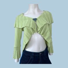 a mannequin wearing a green top with ruffles