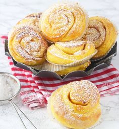 several pastries sitting on top of a table next to a strainer