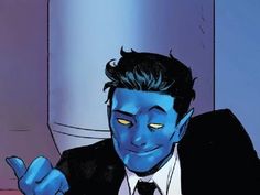 a man in a suit and tie sitting at a table with blue paint on his face