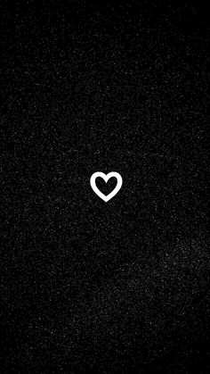 a black background with a white heart in the middle and small dots on the bottom