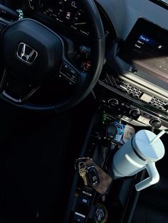 the inside of a car with steering wheel and dashboard