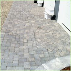 an image of a brick walkway in front of a house that has been cleaned and sealed