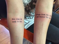 two people with tattoos on their legs that say, in time for the city to fall and rise