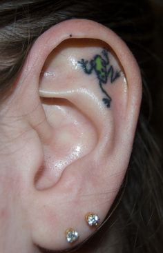 an ear with a flower tattoo on it