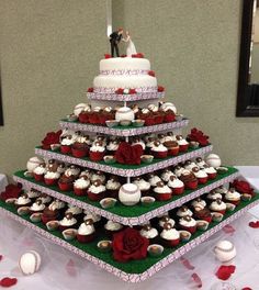 a wedding cake made out of cupcakes on a table